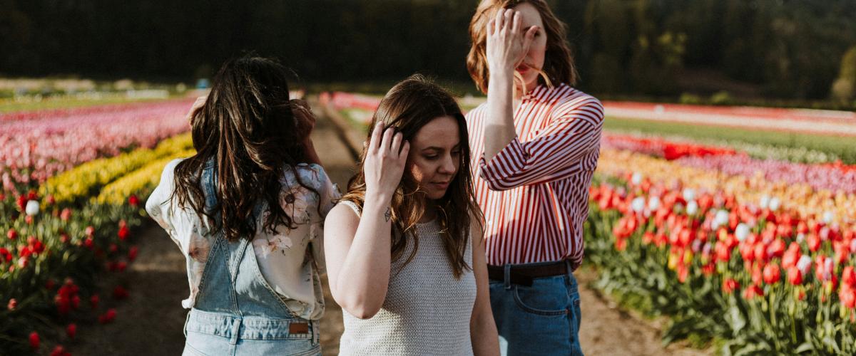 3 women in field of flowers