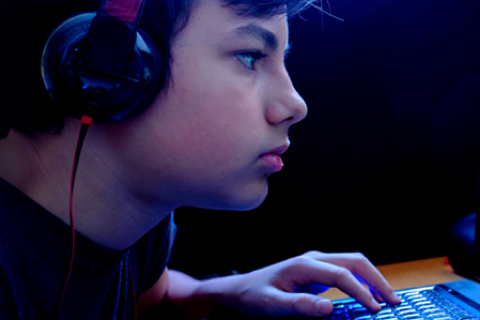 Boy with headphones looking at computer