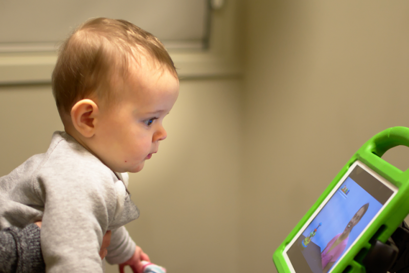Toddler interacting with app on iPad