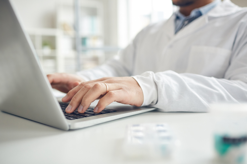 Healthcare provider typing on laptop