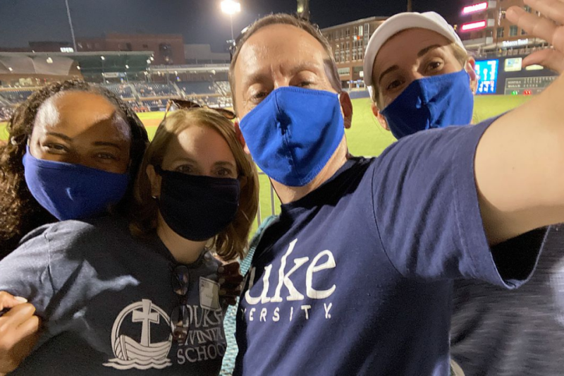 Four colleagues at Durham Bulls game