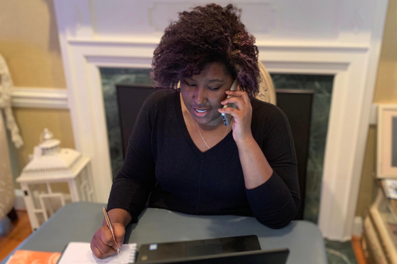 Social worker Marquise Eloi talks with an employee