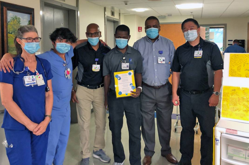 (Left to right) Carol Hobbs and Kai Manu celebrate Duke Raleigh Materials team members Anthony Nobles, Michael Davis, Leon King and Lauro Manahan. Photo courtesy of Duke Raleigh Hospital.