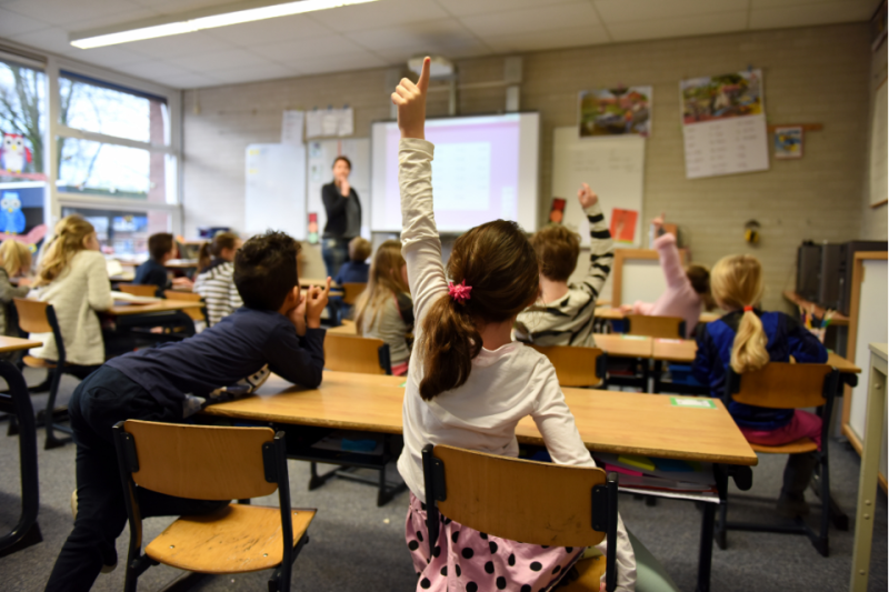 Elementary school classroom with children and teacher