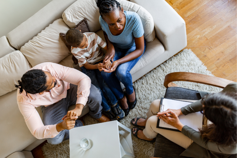 Overhead view of psychologist talking with a family