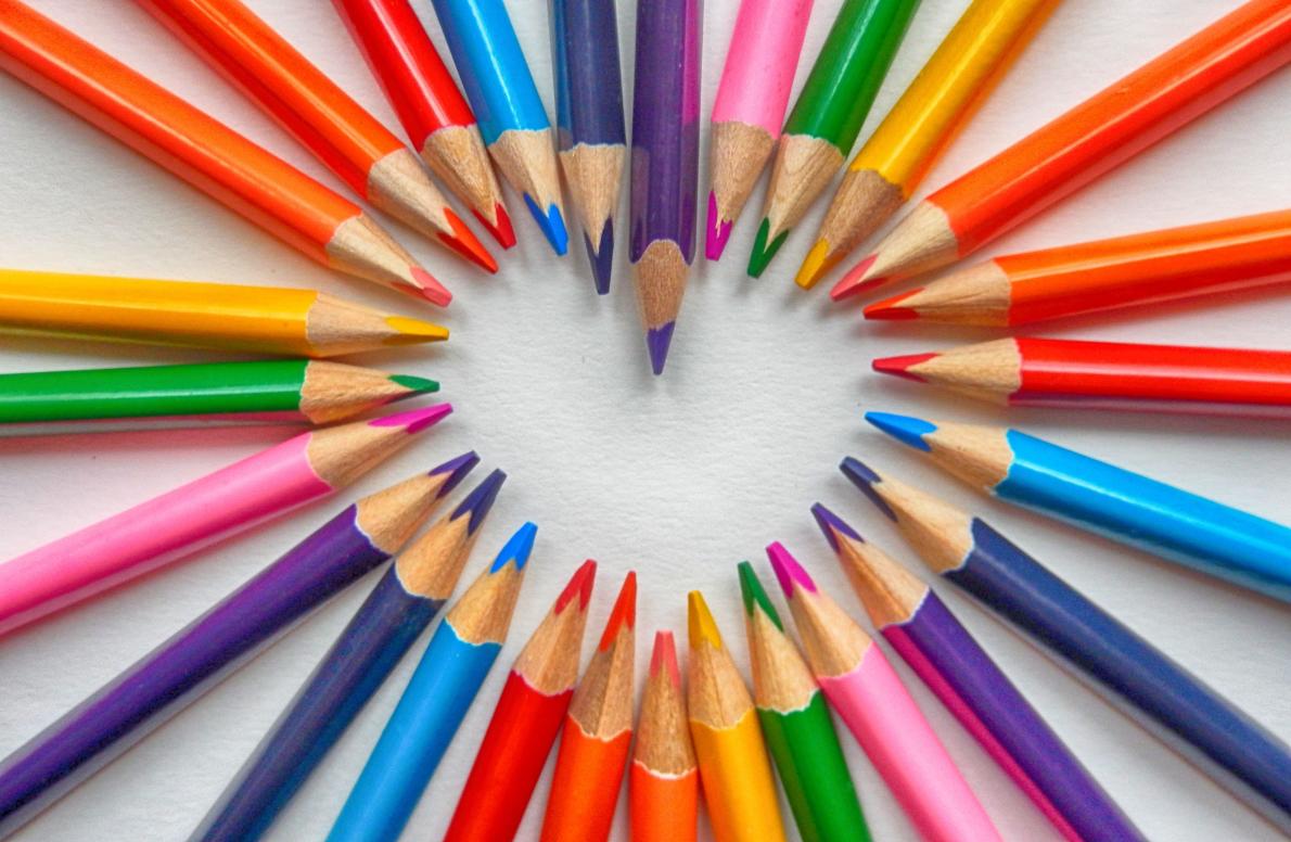 Colored pencils creating the shape of a heart