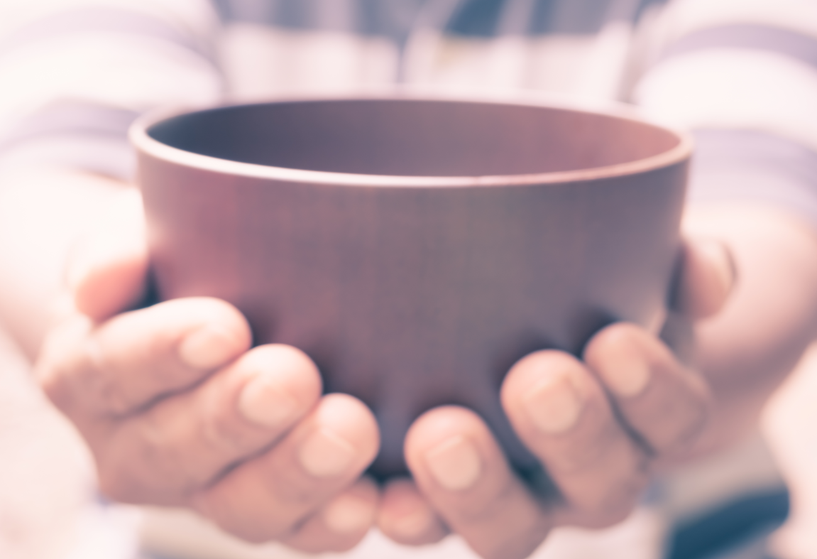 Person holding an empty bowl