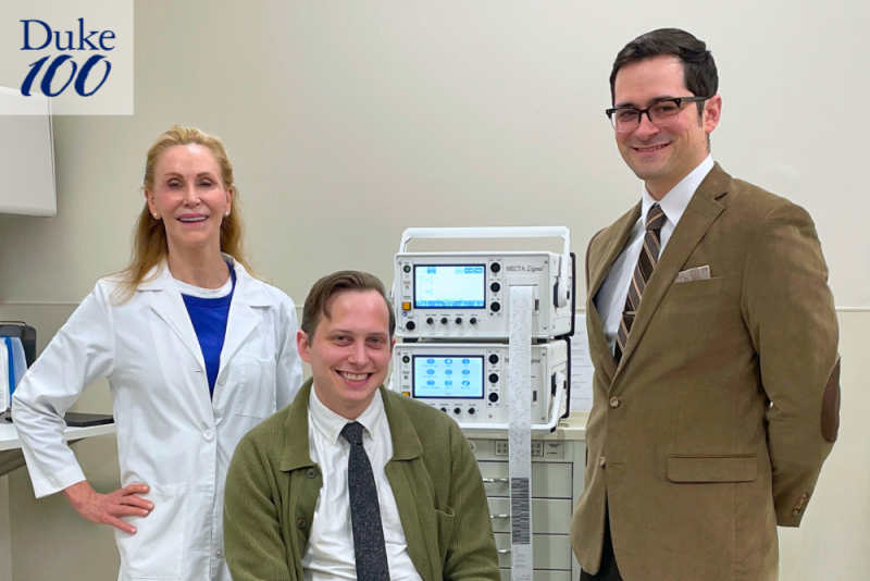 Grace Gunderson-Falcone, Johnny Komisar, and Jake Feigal pose around an ECT machine.