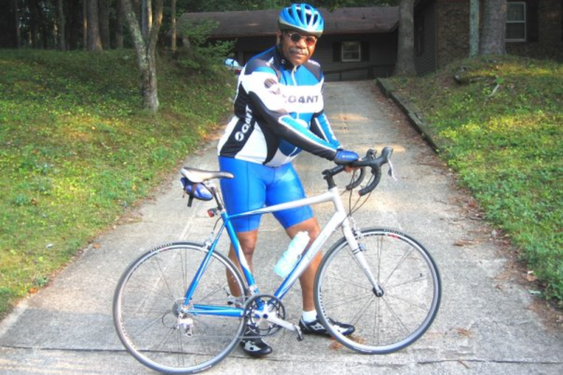 Henry Edmonds standing behind a bicycle