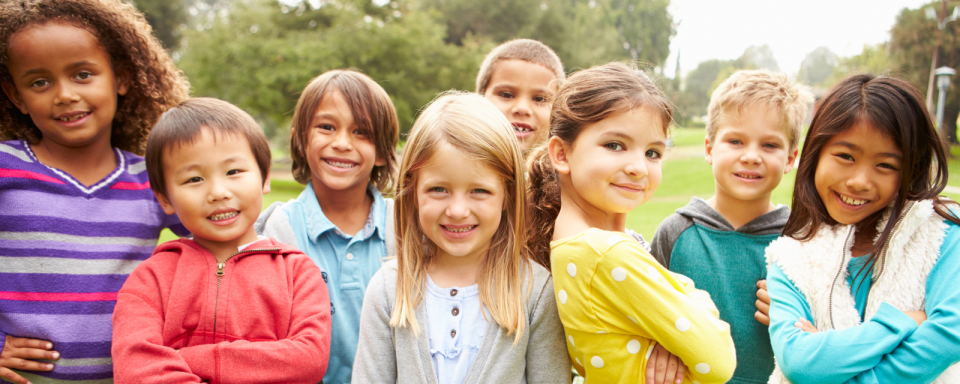 8 diverse elementary school children standing outside