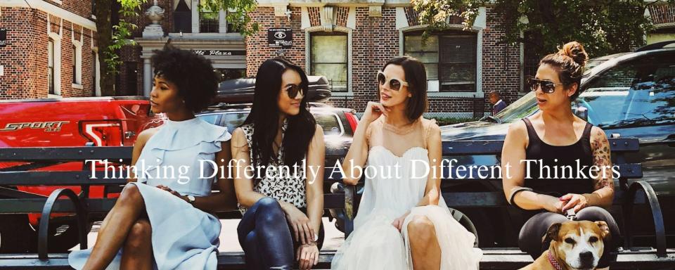 Four women sitting on a bench