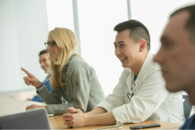Four medical students engaged in classroom conversation