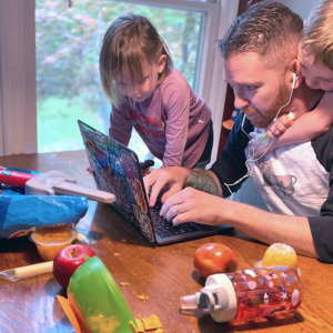 Kyle Fox with his children while trying to work from home. Kyle Fox of University Center Activities and Events has had to balance job duties and childcare while working from home. Photo courtesy of Kyle Fox.