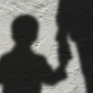Shadow of child holding adult's hand