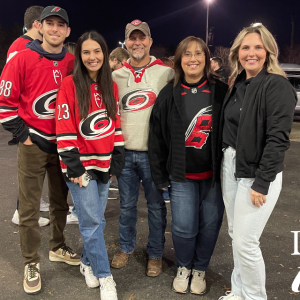 Cathy Lefebvre and her family at a Hurricanes game, decked out in Hurricanes garb