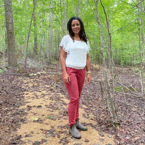 Nora Dennis on a path in the woods