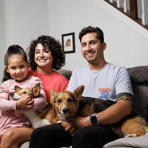 Cancer survivor Iris Bugbee with her husband, Greg, daughter Mila, and corgis, Candi and Charli, at her home in Fuquay Varina in 2024