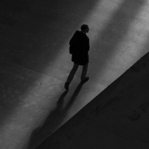 Silhouetted figure walking in the dark