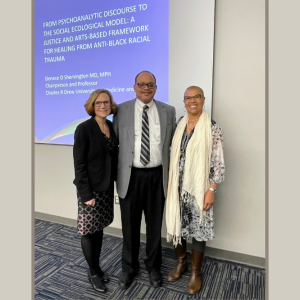 Moira Rynn, Jay Carter, and Denese Shervington in front of Dr. Shervington's title slide.