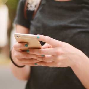 Young person texting. Only hands and phone showing.
